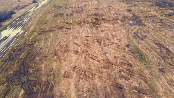 Scattered Heaps of Manure on a Farm Field in the Countryside