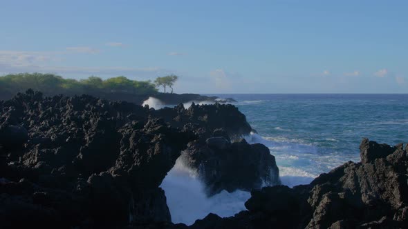 Waves crashing into shore on Hawaii