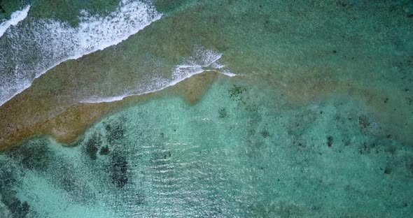 Luxury fly over abstract view of a white paradise beach and aqua blue ocean background in 4K