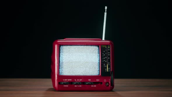 Small Old Television with Grey Interference Screen on Black Background
