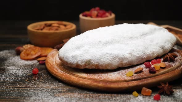 Traditional Christmas Stollen Cake Recipe with Ingredients on Wooden Background