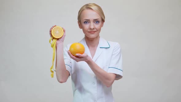 Nutritionist Doctor Healthy Lifestyle Concept - Holding Orange Fruit