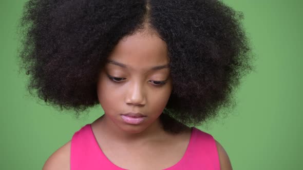 Young Sad African Girl with Afro Hair Thinking While Looking Down