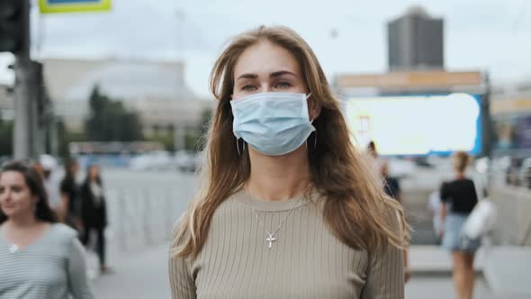 Attractive Girl Masks Walking Street Corona Virus. Crowd Healthy People Covid-19