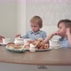 Mum and Dad Joining Their Male Children at the Cafe Table - VideoHive Item for Sale