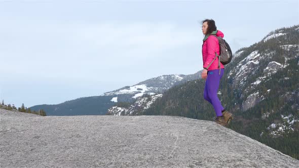 Adventurous Girl Hiking on Top of a Peak