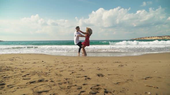 Young Man and Woman Run Towards Each Other on the Beach