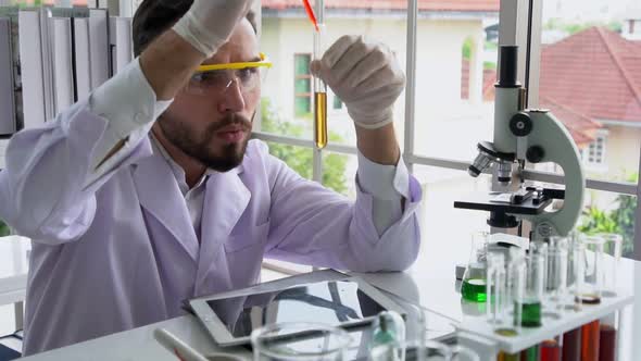 Scientist Work with Science Equipment in Laboratory