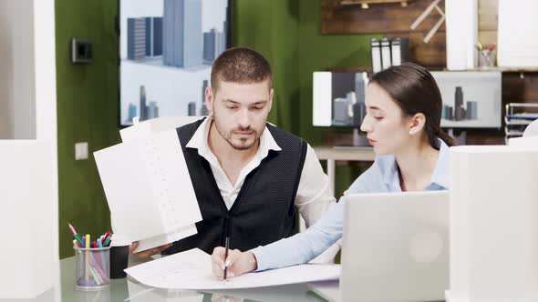 Bearded Engineer Talking with Female Architect About Future Project