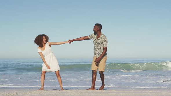 African American couple enjoying seaside