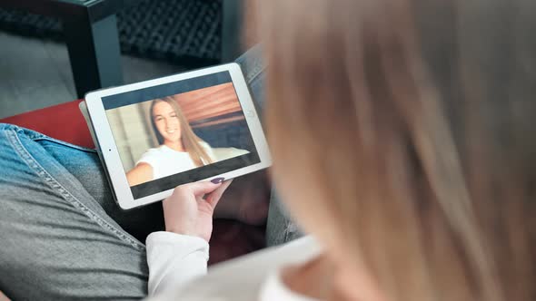 Young Happy Woman Having a Videochat with Her Friend on Digital Tablet