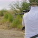 Man Loads a Rifle and Shoots Rear View - VideoHive Item for Sale