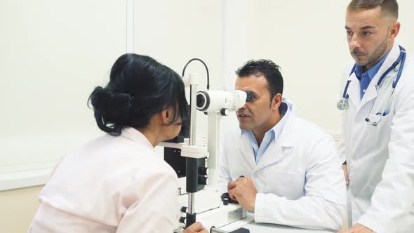 Two Smiling Doctors Check the Patients Vision