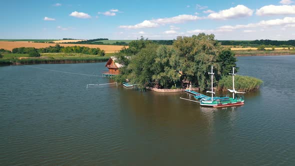 Drone flying over the river to island at daytime in summer.