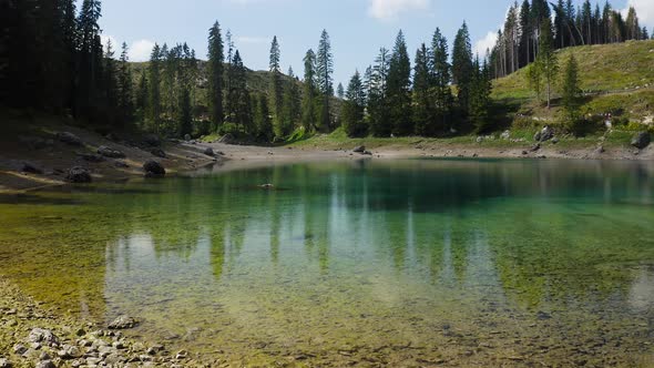 Cam crane on Lake Carezza, Dolomiti, Trentino Alto Adige Italy. This shot shows lake's amazing color