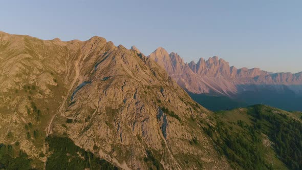 Breath taking golden hour sunrise aerial view wide orbit across South Tyrol Plose Peitlerkofel revea