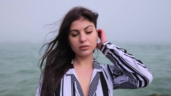 Young Attractive Woman Near the Ocean on a Summer Day