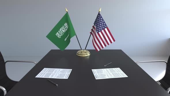 Flags of Saudi Arabia and the USA on the Table