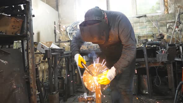 Worker in Protective Mask Welding Metal Construction at Industrial Production