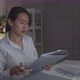 Concentrated Businesswoman looking at paperwork checking and reviewing a business financial report - VideoHive Item for Sale