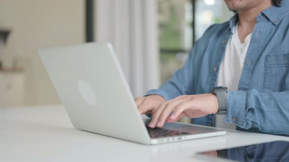 Close Up of Male Hand Typing on Laptop