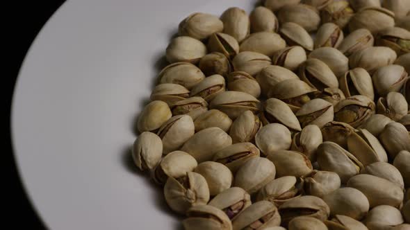 Cinematic, rotating shot of pistachios on a white surface - PISTACHIOS 013