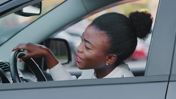 Young Afro American Girl Driver Stressed African Ethnic Woman Sitting in Car in Traffic Jam