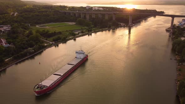 Large General Cargo Ship Tanker Bulk Carrier at Sunset Aerial View