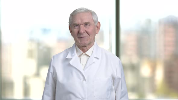 Old Senior Cheerful Man in White Coat Smiling