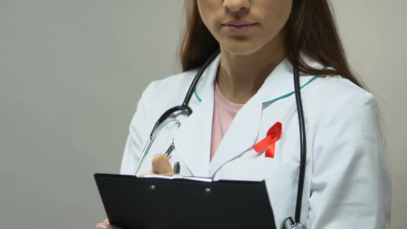 Therapist With Red Ribbon Prescribing Medication Fight Against AIDS Epidemic