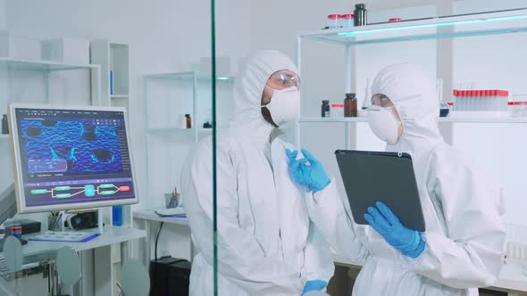 Team of Scientists in Ppe Suit Using Virtual Reality in Chemistry Lab