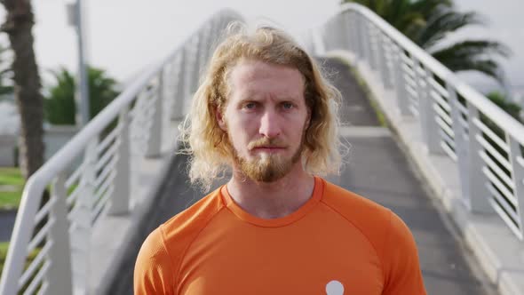 Sporty Caucasian man on a bridge