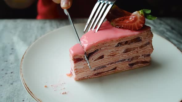 a Girl Cuts a Piece of Strawberry Cake with a Knife