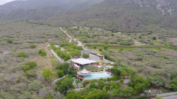 Luxury resort structure with mountains in background at Bahia de Ocoa bay in Dominican Republic. Aer