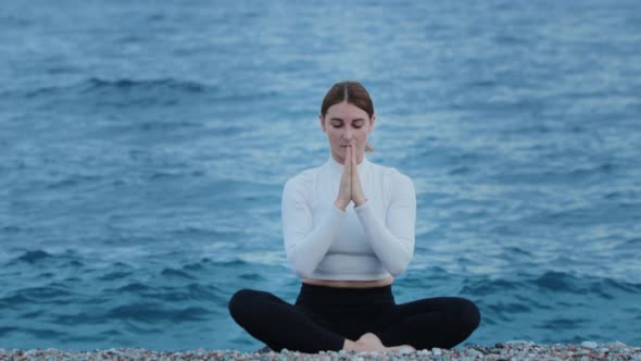 Sports Outdoors  a Woman Doing Yoga By the Blue Sea