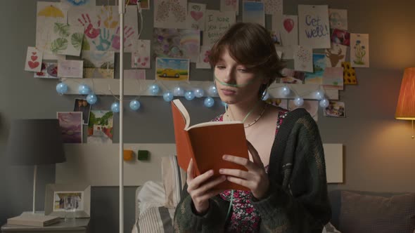 Teen Girl Reading Book in Hospital Ward