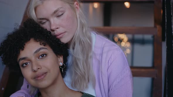 Young Girl Hugging Her Girlfriend From the Back and Smile Looking at Camera