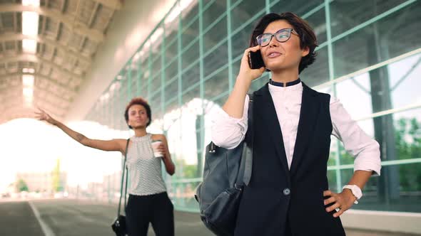 Young Beautiful Businesswoman Speaking on Phone Standing Near Business Centre