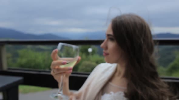 the Girl Drinks White Wine Sexy Young Woman with Glass of Wine