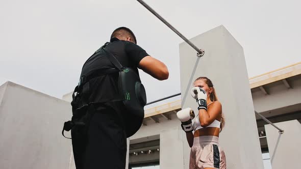 Boxing Training at the Construction Site Young Fitness Woman in Boxer Gloves Training Her Punches