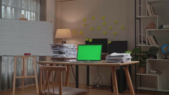 Green Screen Laptop With Documents On The Table At The Office