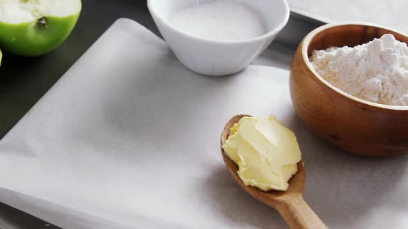 Bowl of sugar and apple, flour with butter in spoon 4k