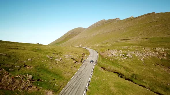 Aerial View of a Scenic Road with a Car Arriving to Slaettaratindur Mountain