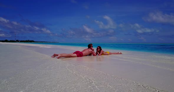 Beautiful couple married on vacation enjoy life on beach on sunny white sandy 4K background