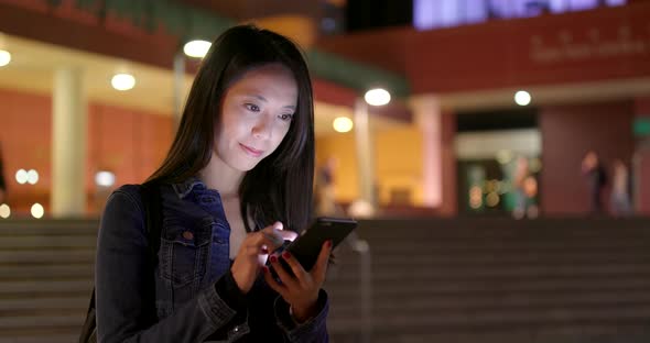 Young Woman use of mobile phone at night