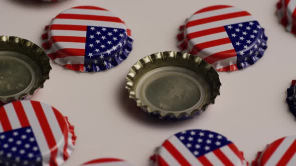 Rotating shot of bottle caps with the American flag printed on them 