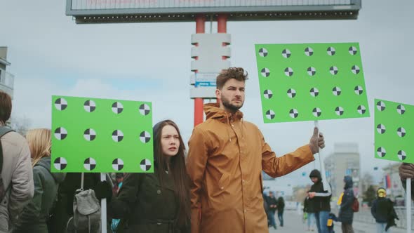 Male and Female Activists with Chromakey Banners Protest for Green Planet Saving