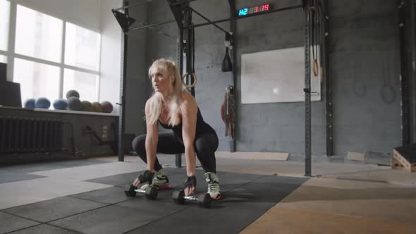 Female Athlete Doing Burpees in Gym alt