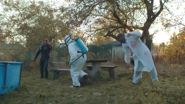 Two Zombies Attacking Disinfector in Abandoned Courtyard