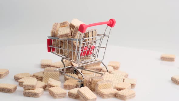 Spinning Pile of Square Wafer Biscuits and Shopping Cart